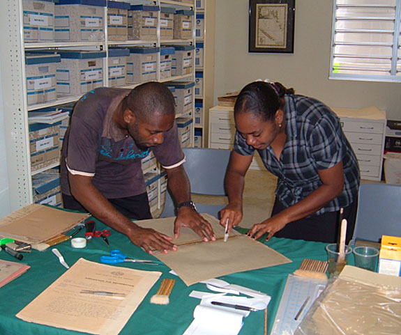 Augustine Tevimule and Nellie Caleb conserving documents